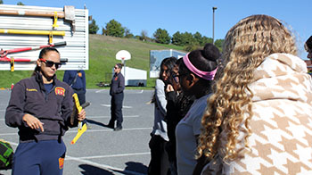 Firefighter Cristine Hostetter shows the class how to use the tools in the ambulance. 