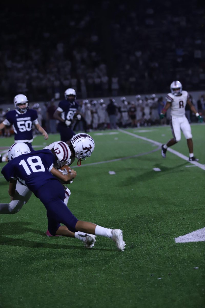 Kingston Lehman tackles #12 on the other team.