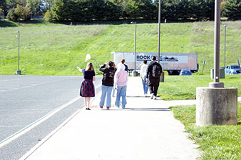 Earth Club members walking towards field. 