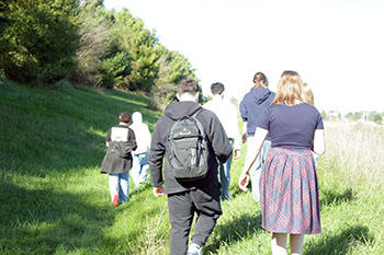 Another shot of the Earth Club walking through the grass. 