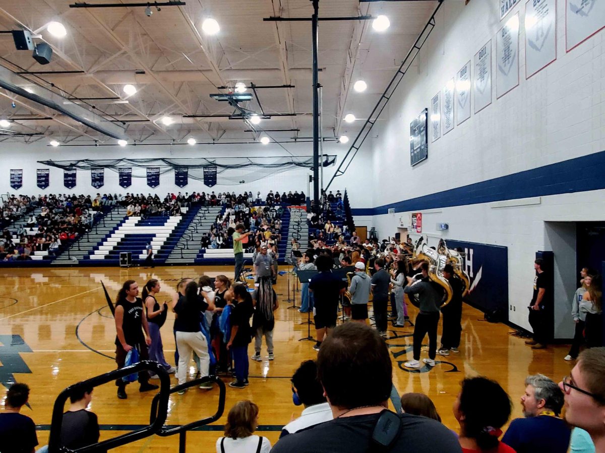 The HHS band plays music loudly, loud enough to hear outside the gym!