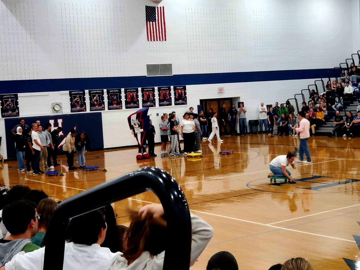 Biology teacher Anna Henkel shows an example of how to play the game to the players.