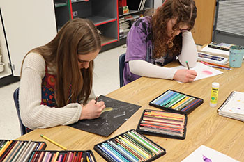 Junior Lilly Carpenter and Claire Keller are both working on their art projects.