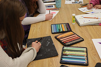 Junior Lilly Carpenter is adding finishing touches to her art project.