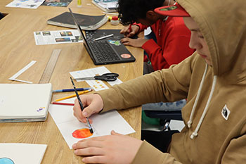 Sophomore John Cassel is working on his ombre circles using water colors.
