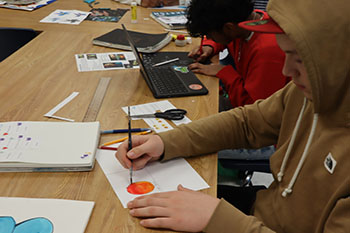 Sophomore John Cassel is working on his ombre circles using water colors.