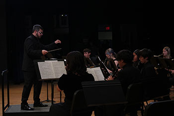 Director Brian Incheck is conducting the students throughout the concert.