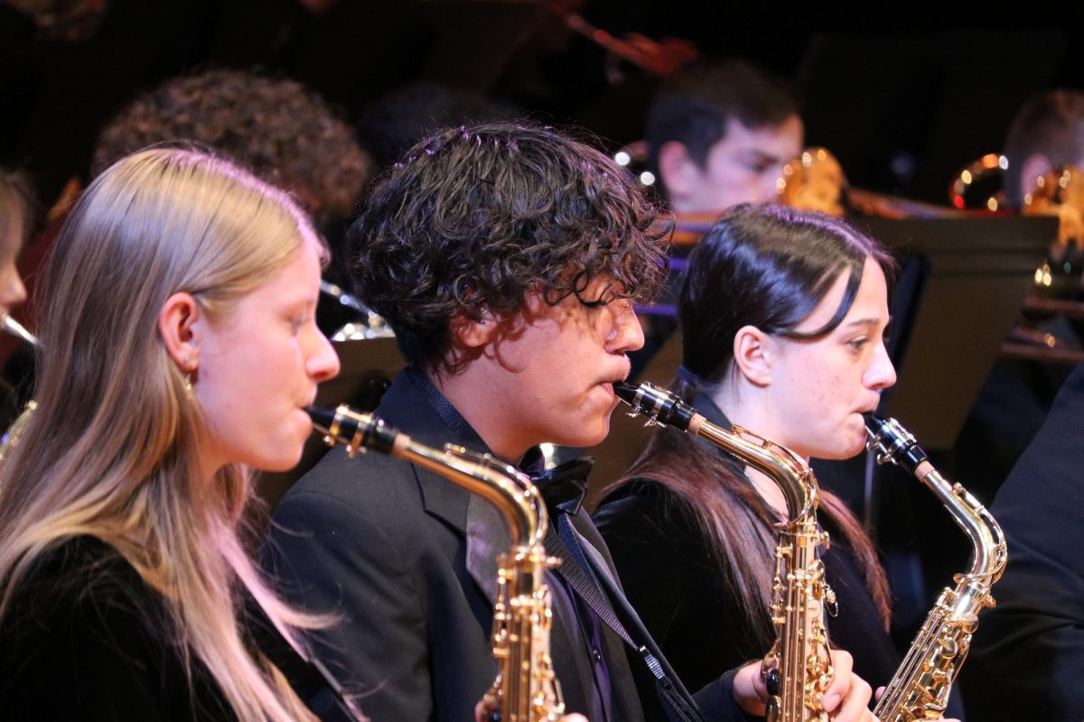 Junior Carlos Lopez plays the saxophone at the Prism Concert.