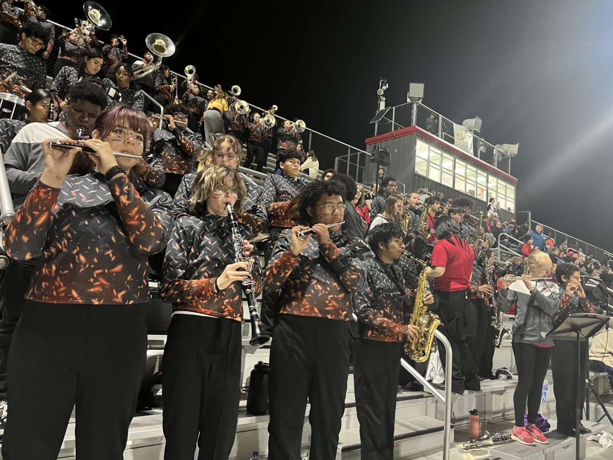 Olivia Carickhoff plays the piccolo with the entire band from both Harrisonburg and Rocktown High school for the RHS football game.