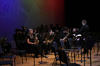 United in harmony, the band delivers an unforgettable performance, showcasing their passion and teamwork.