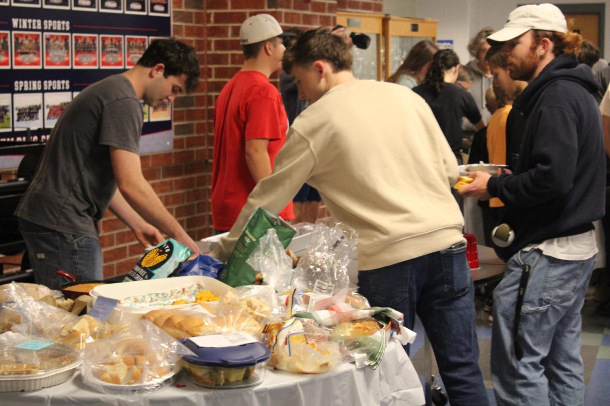 Students choosing some of the many kinds of bread.