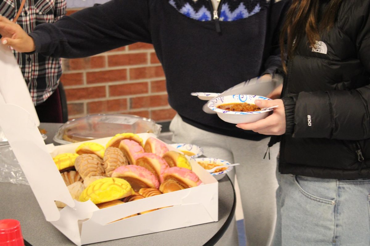 students trying hispanic pastries called conchas.