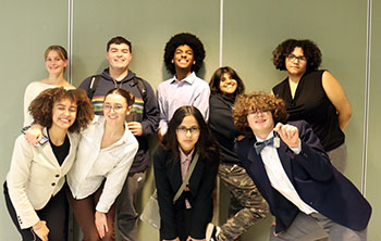 The Debate team takes a group photo after the awards. Carter Stiehl shows off his second place dog tag.