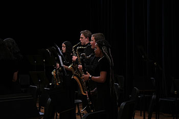 Young talents harmonize their skills, creating a symphony of melodies with their saxophones.