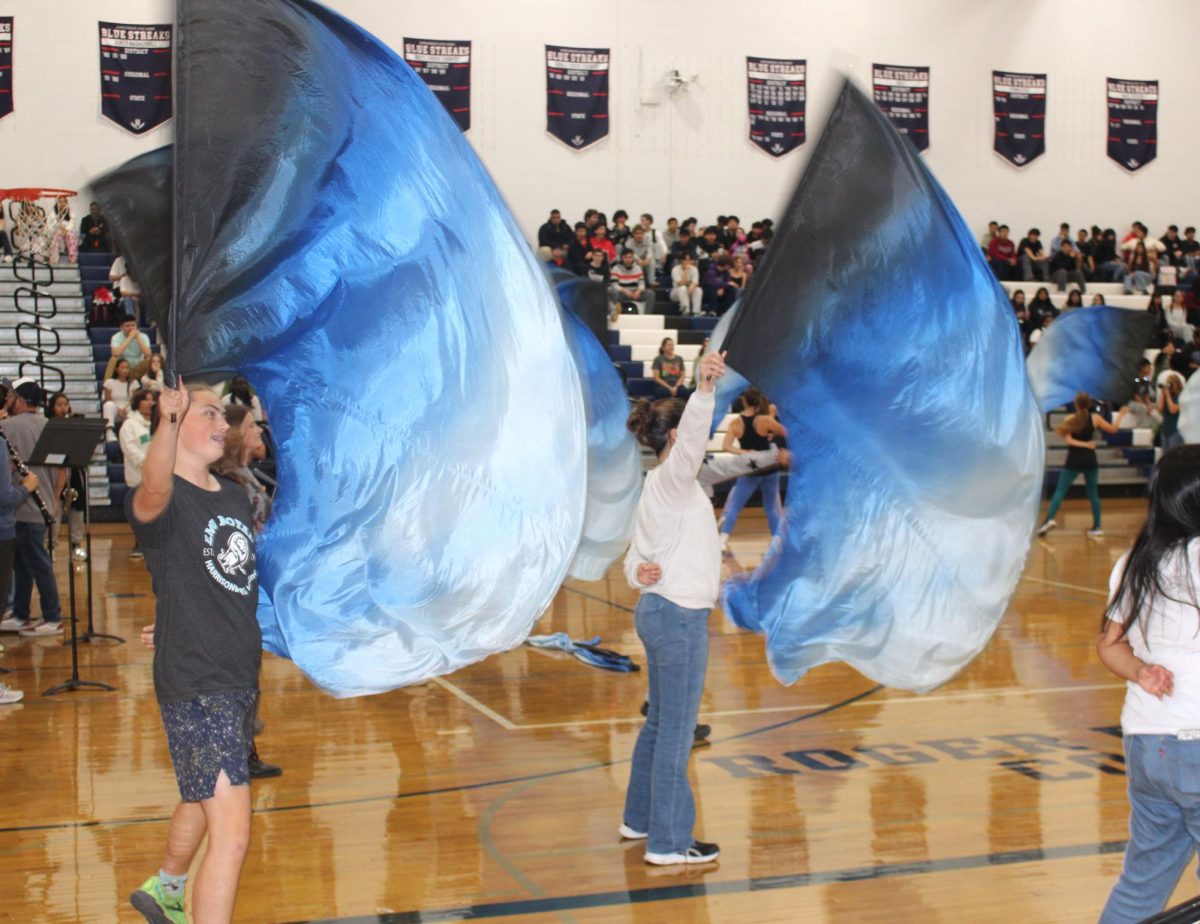While students and teachers were arriving in the gym for the homecoming Pep Rally event, the color guards were performing for an entrance into the activities Harrisonburg High School had for us to celebrate. The Color Guards were doing a fantastic job performing. They were all in sync and ready when it was their cue to start and end.