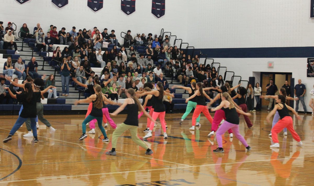 After the usual band music and Color Guard intro in the Pep Rally, we began to introduce the clubs and sports that were centered here in Harrisonburg High School. One of the many sports was the dancers. The dancers began their beautiful dance performance, it was very intriguing to see and watch.
