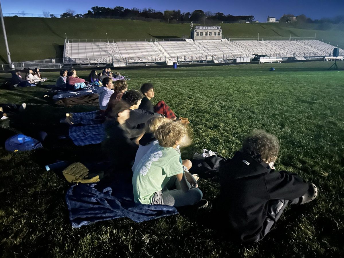 Students enjoying film on the field.