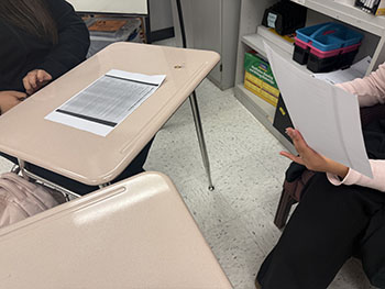 Students practicing on what to say next. Talking to each other to learn how to speak well.