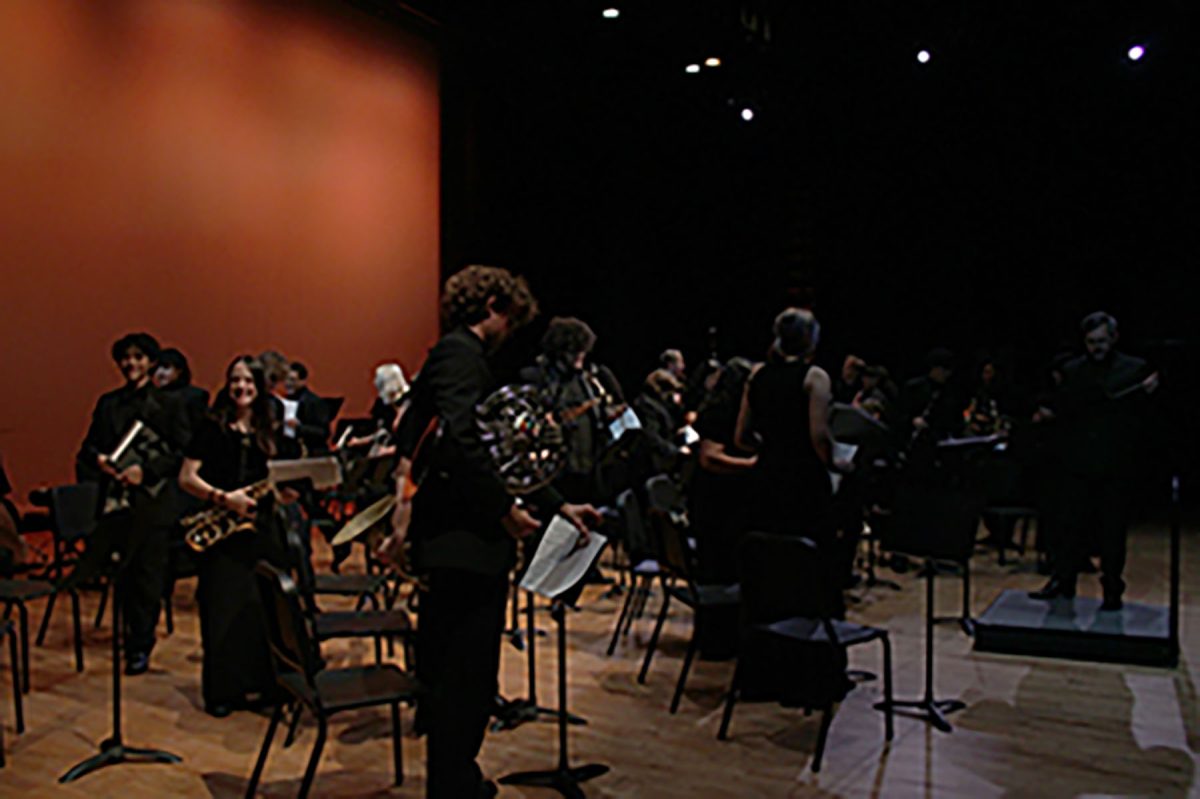 Beaming with pride and joy, the band celebrates a successful concert together.