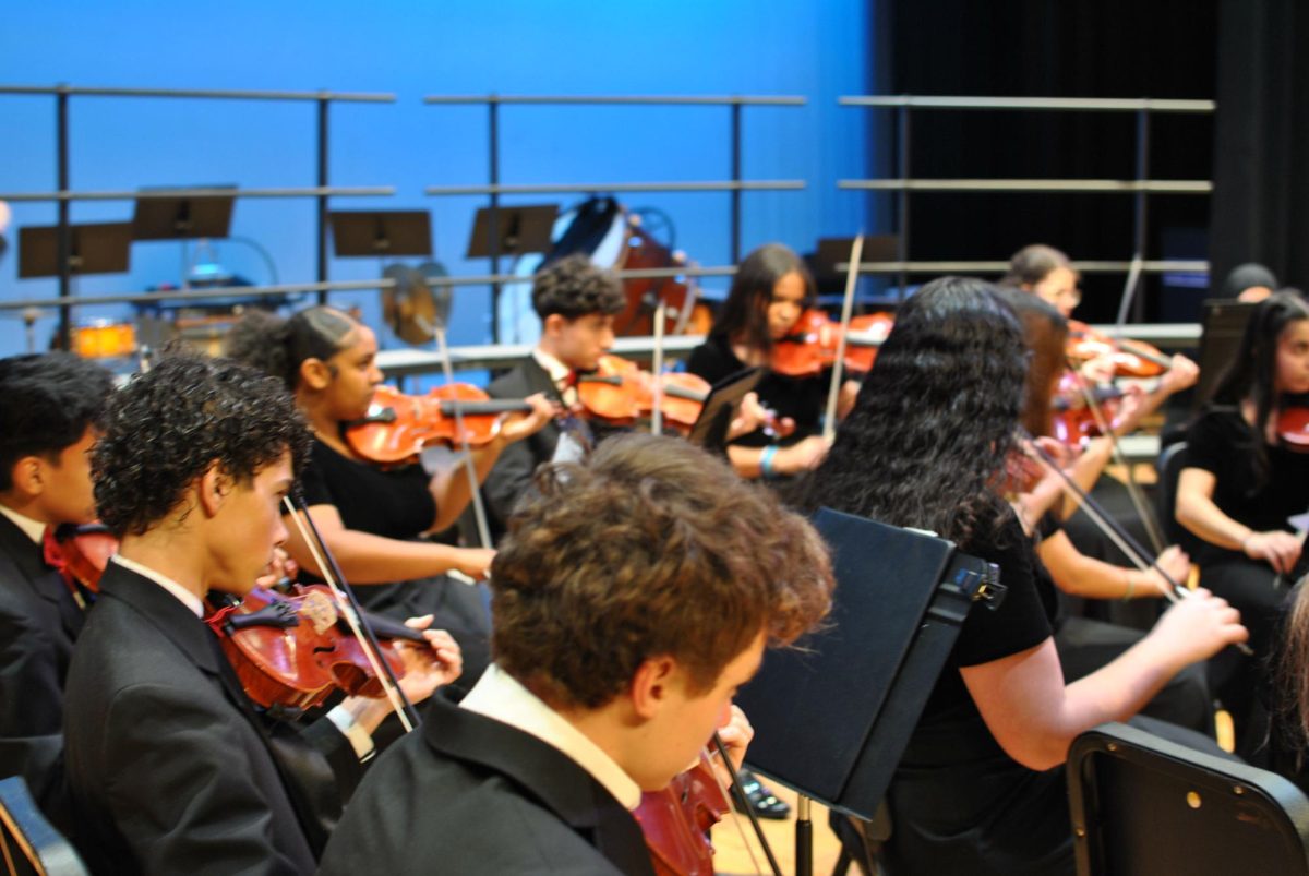 Close up of the violin section of the orchestra.
