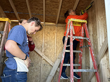 Volunteers entering the shed.