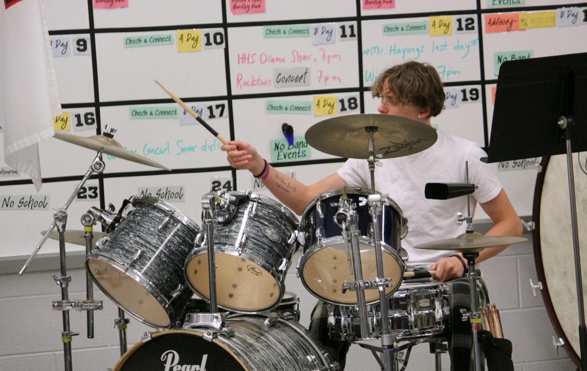 Junior Eli Long jams on the drum set.