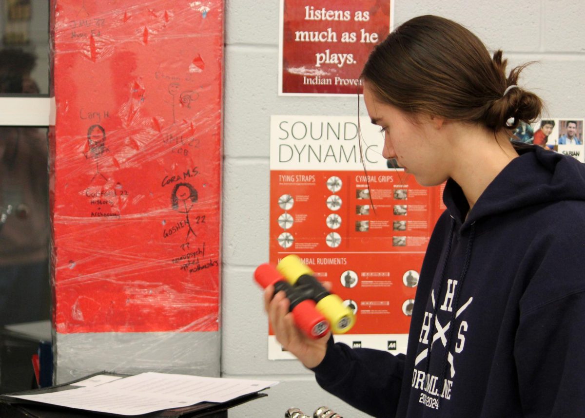 Junior Elsie Corriston keeps beat with a shaker.