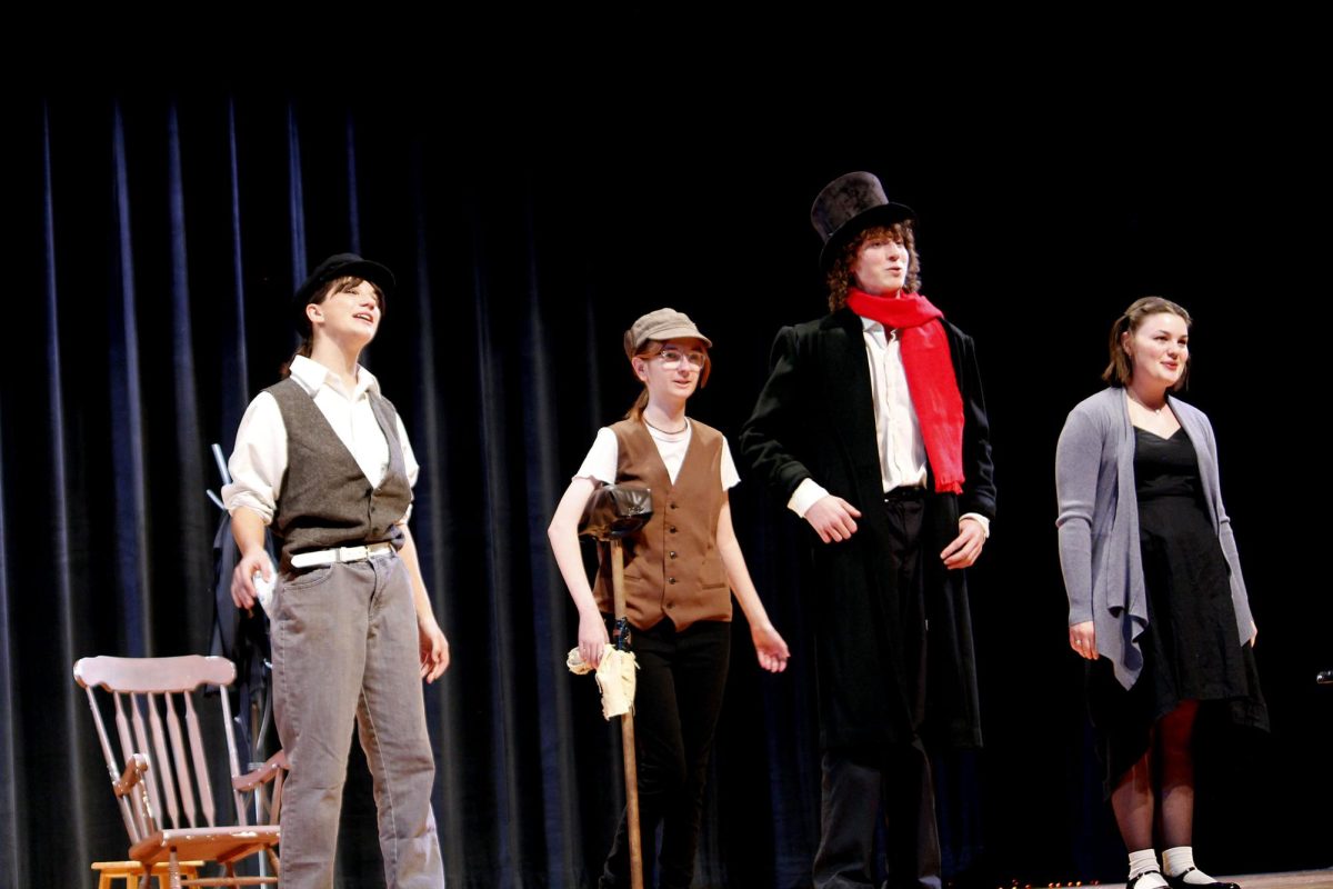 Standing side by side, the cast sings a song to end their performance.