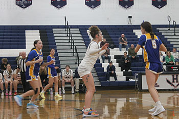 The girls basketball team were playing a hard game. The girls did all they can to try to win.