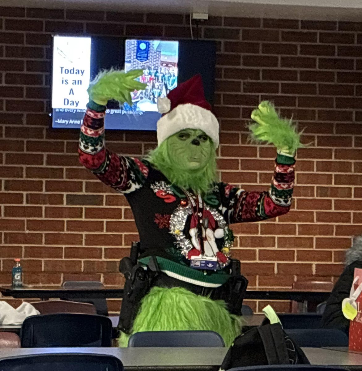 Resource officer dressed as the grinch packing heat.