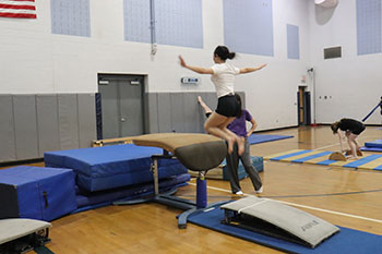 Trinity working on her vault skills.