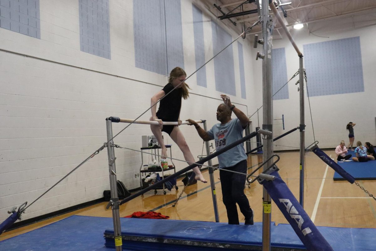 Trying to stand on the bars.