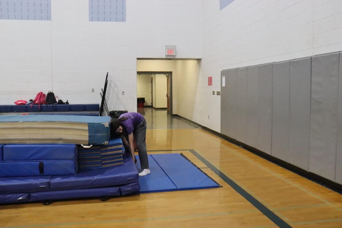 Coach steph fixing the mats.