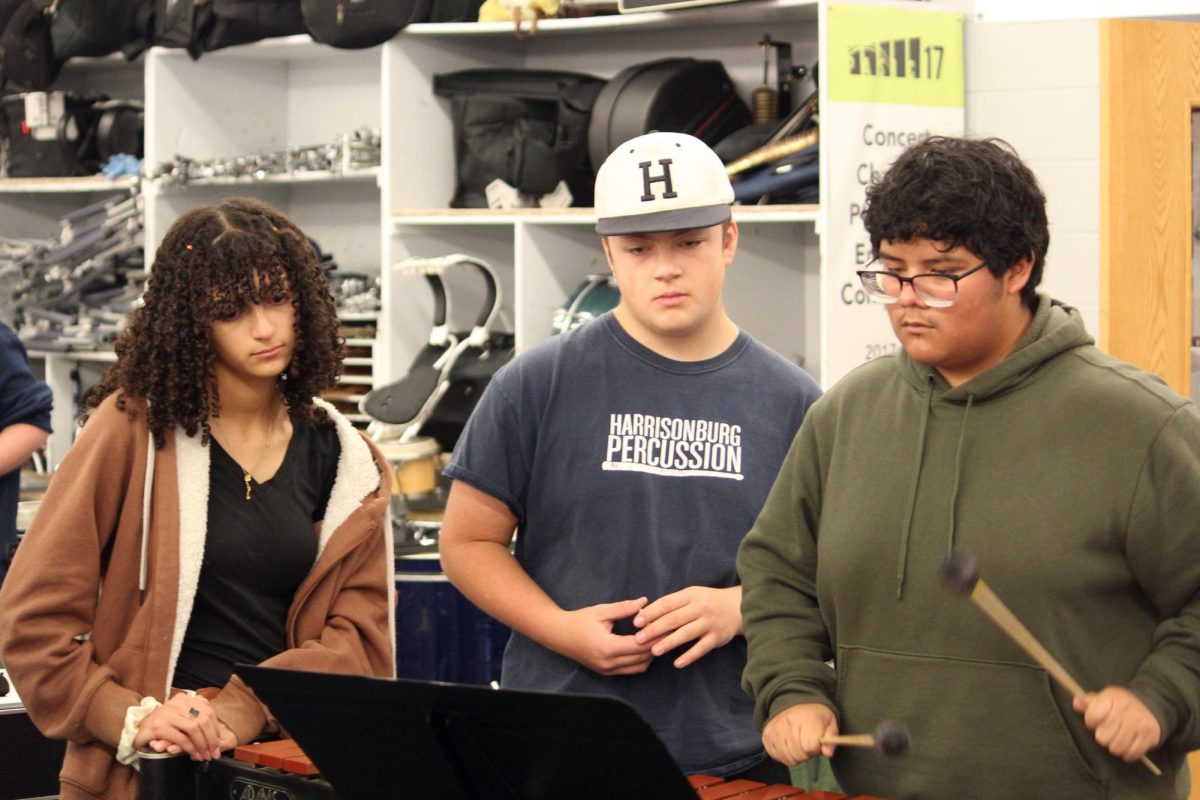The percussion class sight reads a new piece of music.