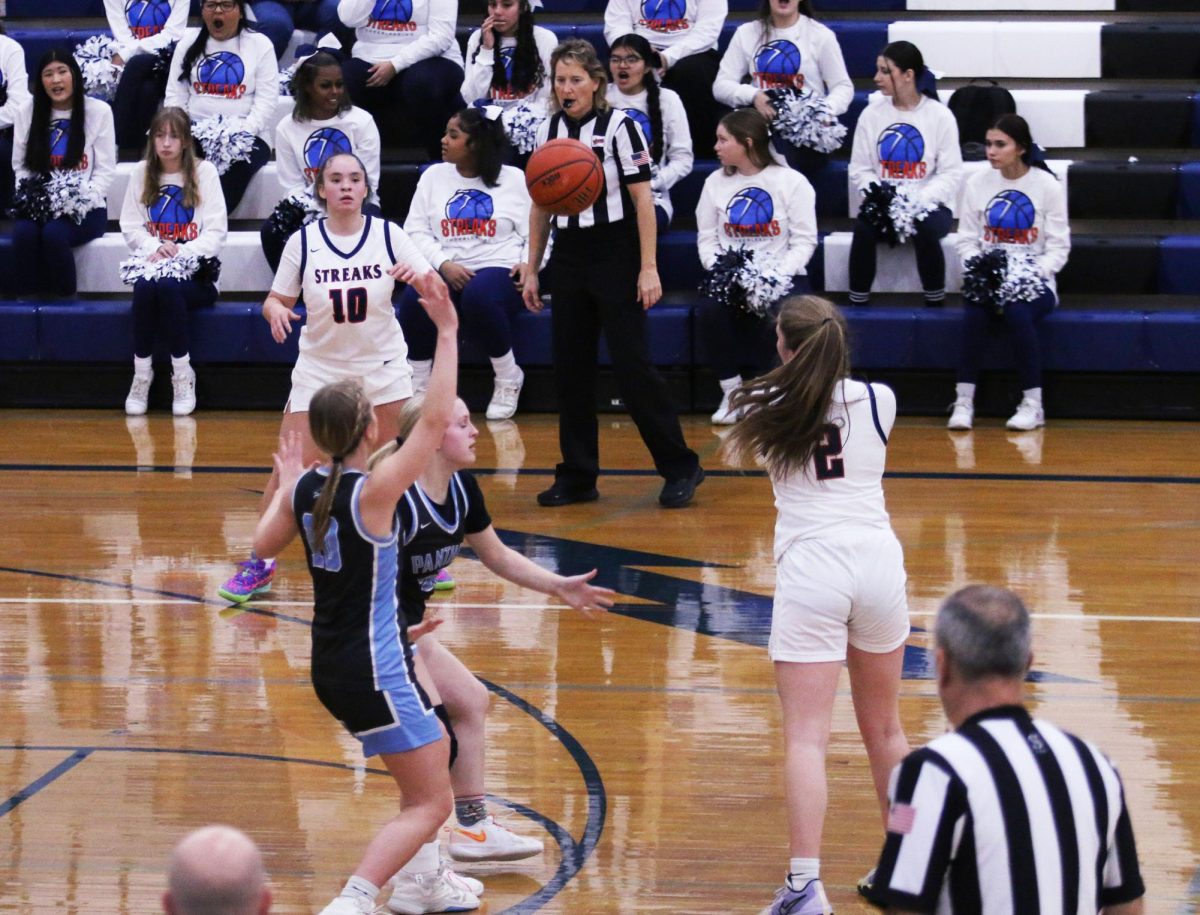 McKenna Dayton passes the ball to Ah-Gia Jones