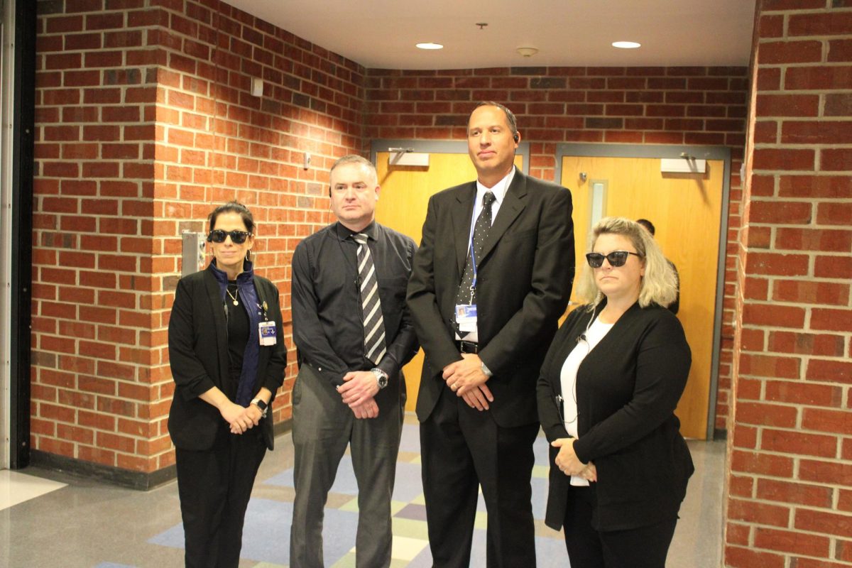 Mr. Burgess and other staff members with their spy outfits.