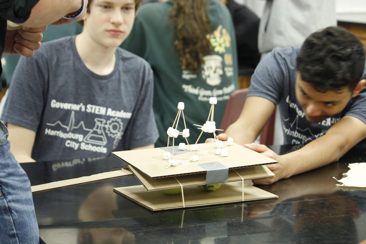 Sophomore Luke Snider looks on as his marshmallow structure withstands the shake of a simulated earthquake.