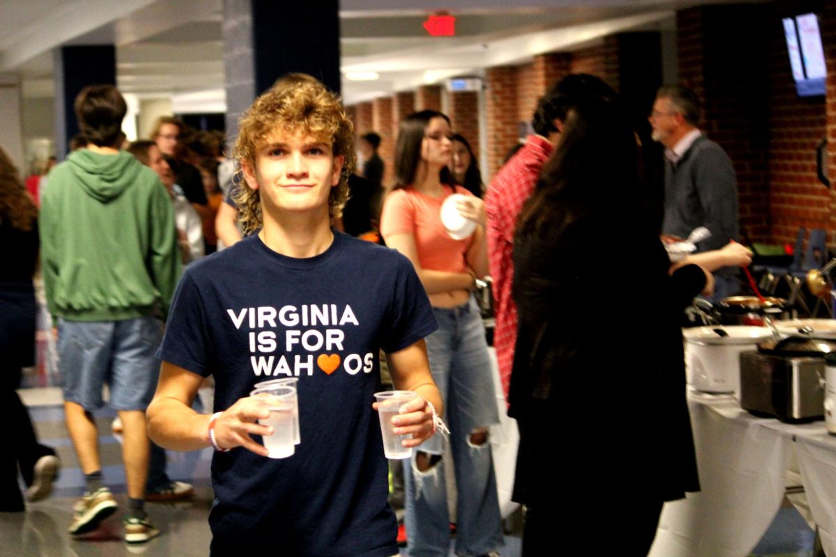Sophomore Wesley Swartz sports a UVA t-shirt while carrying water to his peers. 