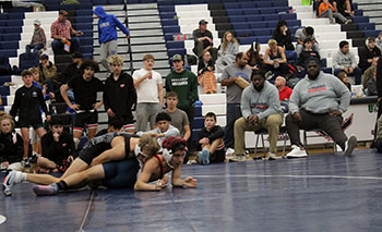 Senior Izaack Cruz being watched by his coaches.