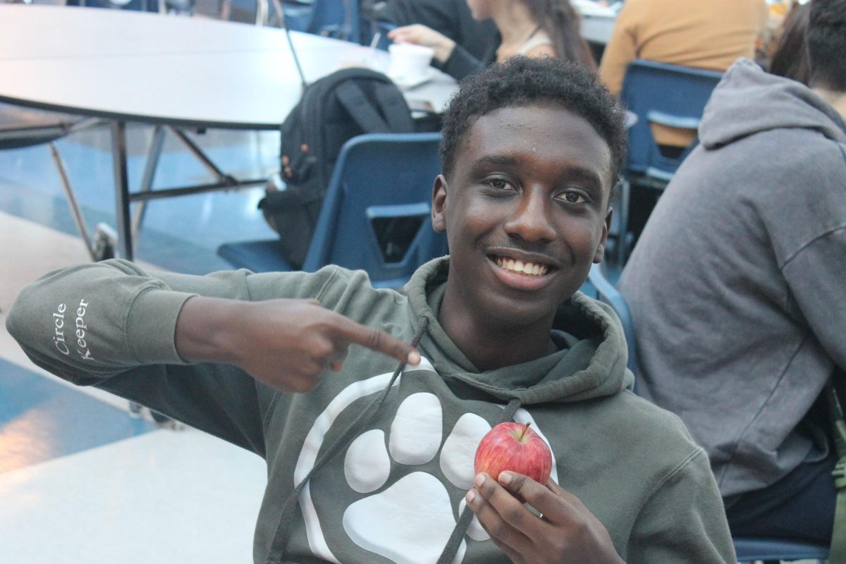 Yousef eating his apple at lunch