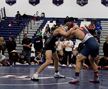 Wrestler Izaack Cruz head to head with his opponent.