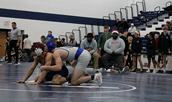 Rockbridge wrestler on top of Harrisonburg senior wrestler Izaack Cruz.