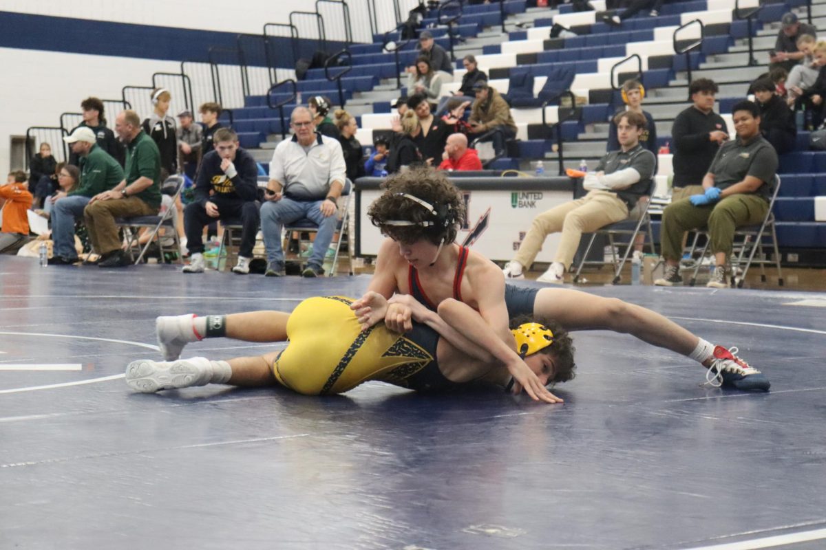 Mason George strategically pinning his opponent. 