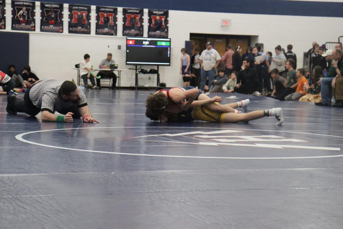 The referee watching Mason George's match closely. 