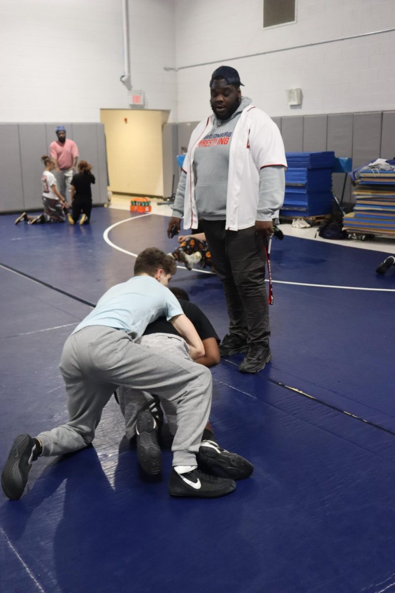 Coach White observing his wrestlers. 