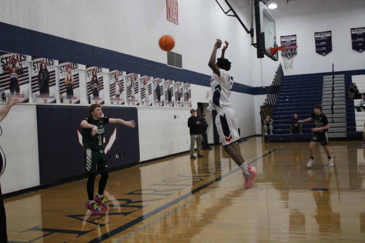 (NAME) does everything he can to block the ball from going to another opponent. (L NAME) jumps as high as he possibly can to try and stop the basketball from going over him.