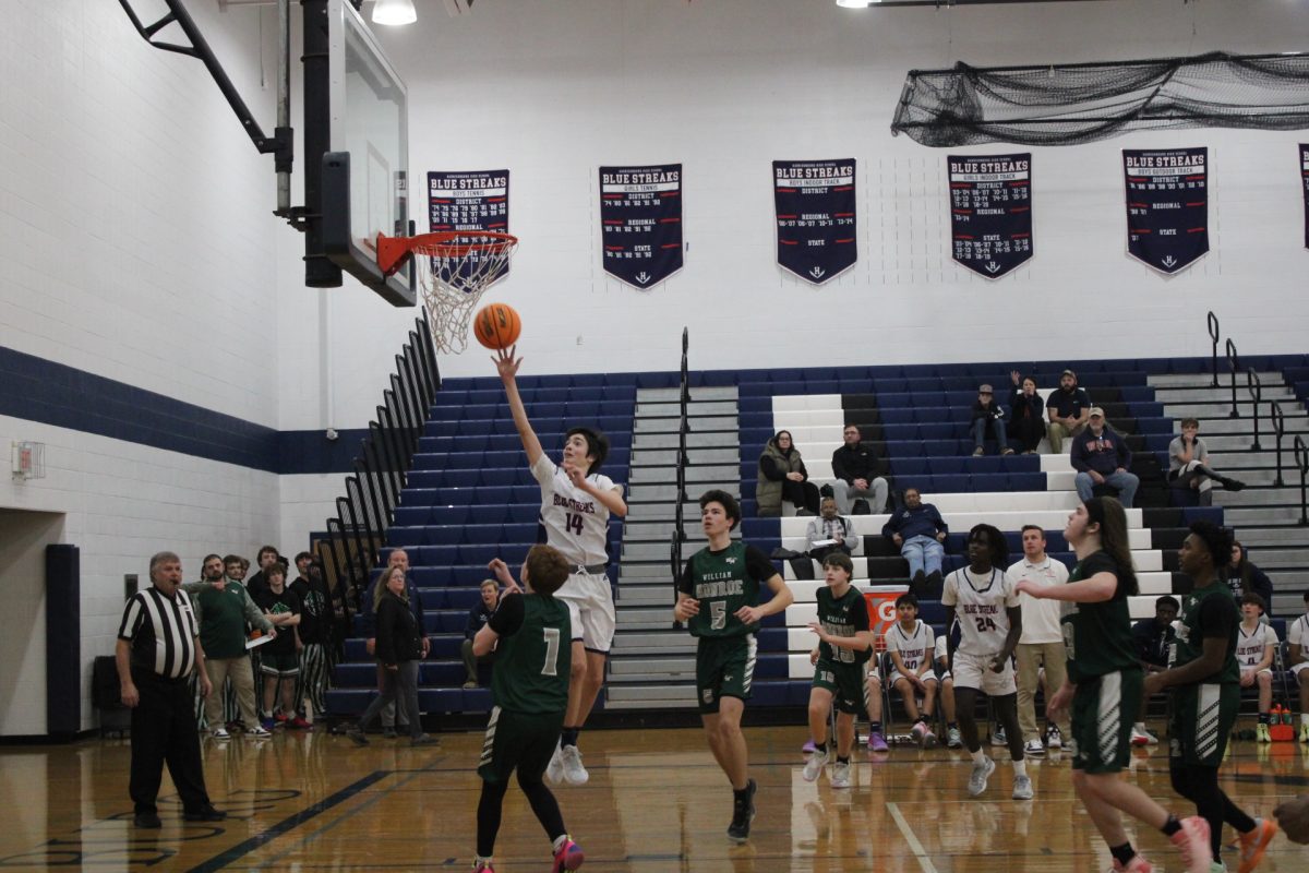 Sami Gebrehai manot runs as fast as he can to take back the basketball and have the basketball all to himself. Gebrehai gets into position and jumps to try and make a shot through the hoop.