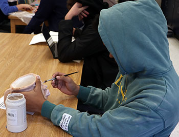 Angel Andujar glazing his "ugly mug" project.