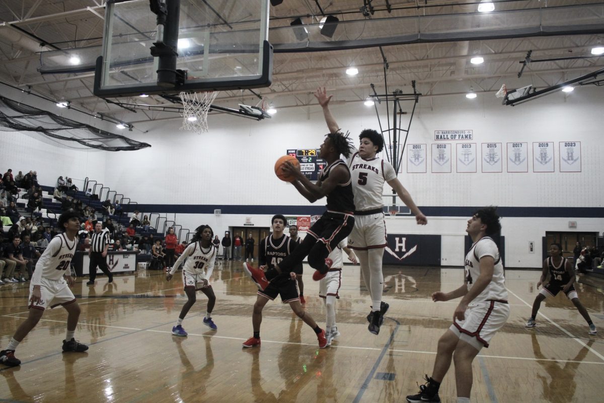 Yandel Robles jumps as high as he can to try and block the ball from going in the hoop