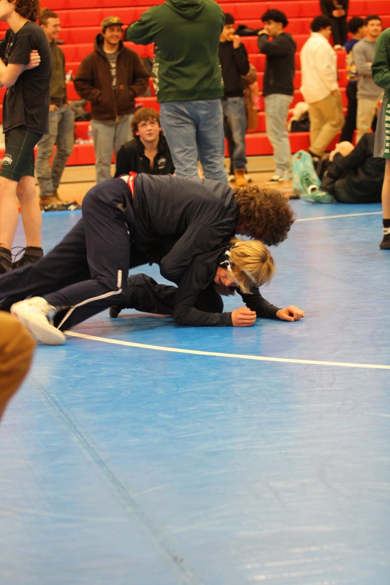 Freshmen Mason George and Malachi DiGennaro practicing before their match